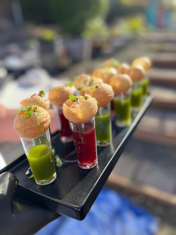 Golgappa shot glasses with crispy puri shells, mint and tamarind chutney