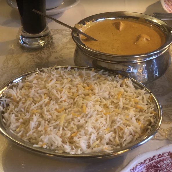 Basmati rice pilaf served alongside a creamy curry