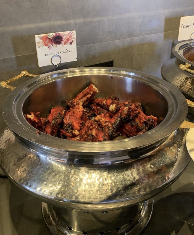 Tandoori chicken in a hammered steel chafing dish